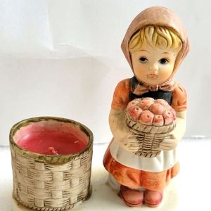 Ceramic figurine a girl with flowers and a candle